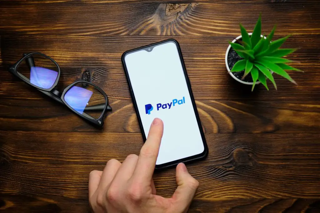 A person using a PayPal app on their phone