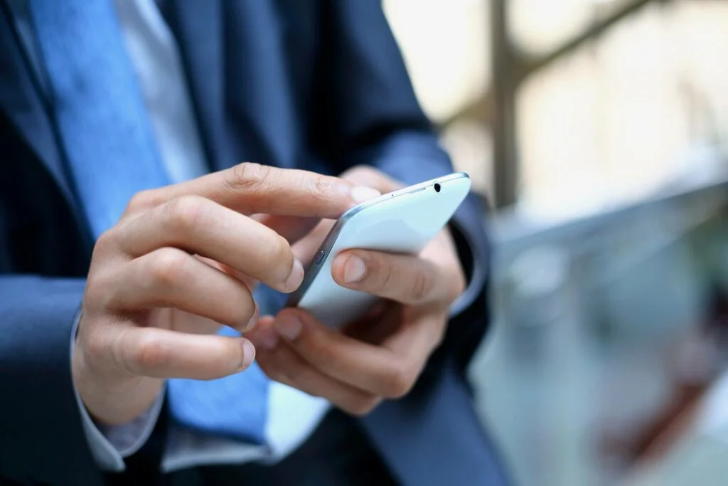 A person typing on the phone