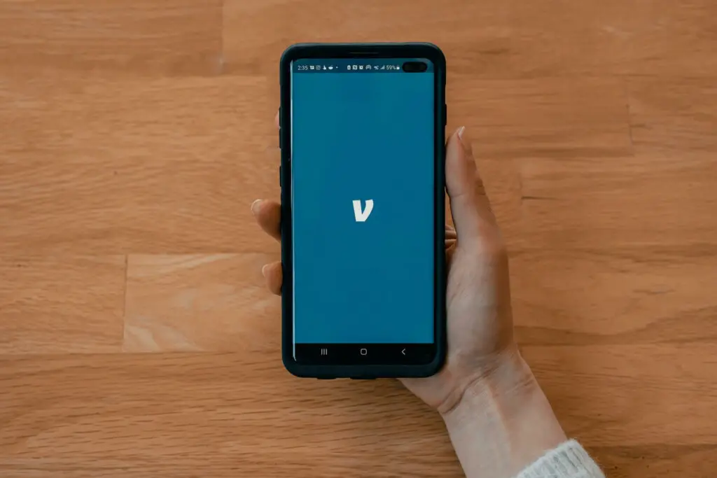 A person opening a Venmo app on a smartphone 
