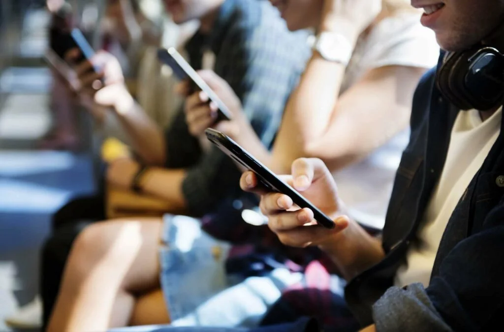 People sitting and using their smartphones