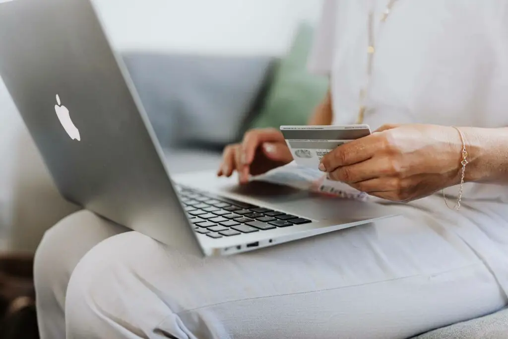 Woman using a laptop and a credit card