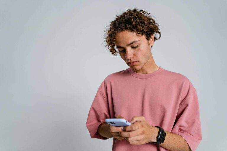 A teenager holding a smartphone