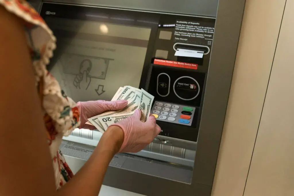 A person withdrawing cash from an ATM