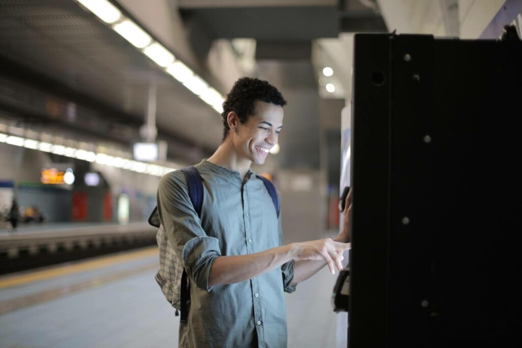A person smiling and using an ATM 