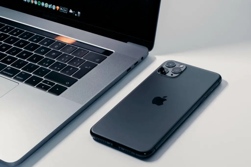 An iPhone next to a Macbook